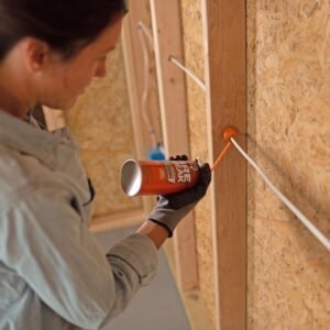 Fire stopping sealant being applied to seal a wall penetration for passive fire protection