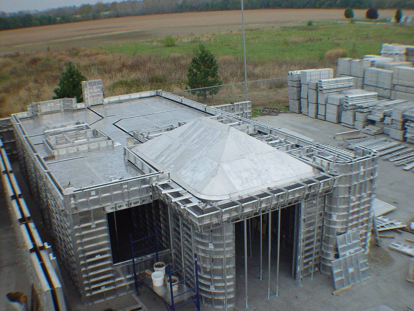 Formwork panels after striking, stacked at the side of a construction site
