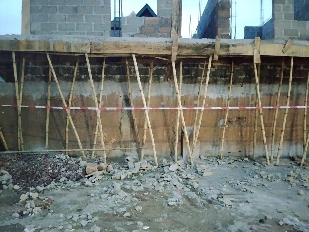 Wall formwork with bracing and alignment supports holding panels plumb