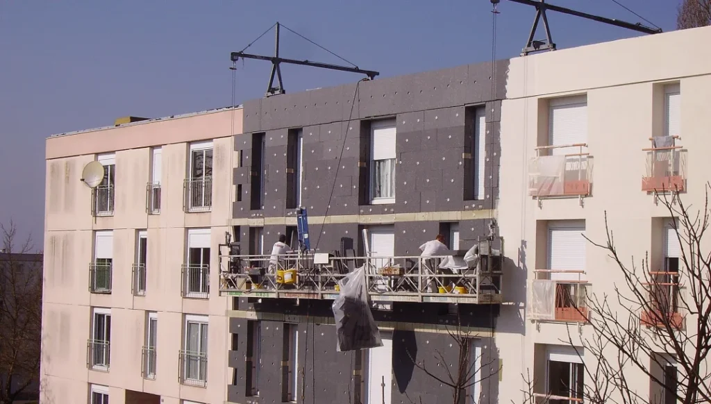 Rigid insulation boards being fixed to a building facade