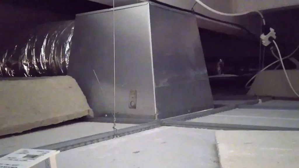 Ventilation ductwork running above a ceiling, where fire dampers cross compartment walls